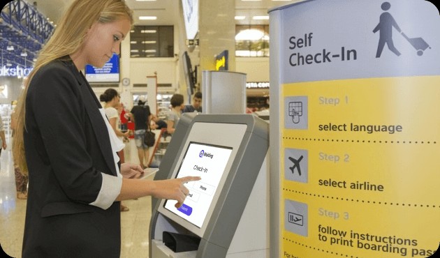 passenger using self-check-in kiosk at airport