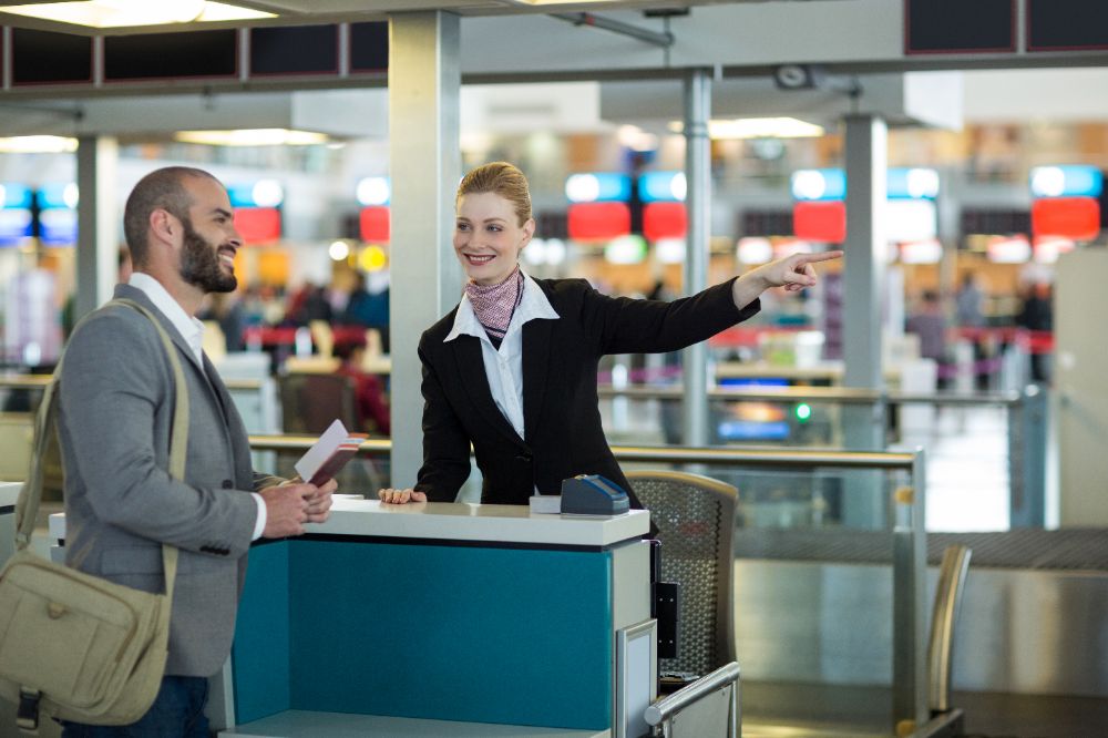 Airline Check-in Attendant Guiding a Passenger