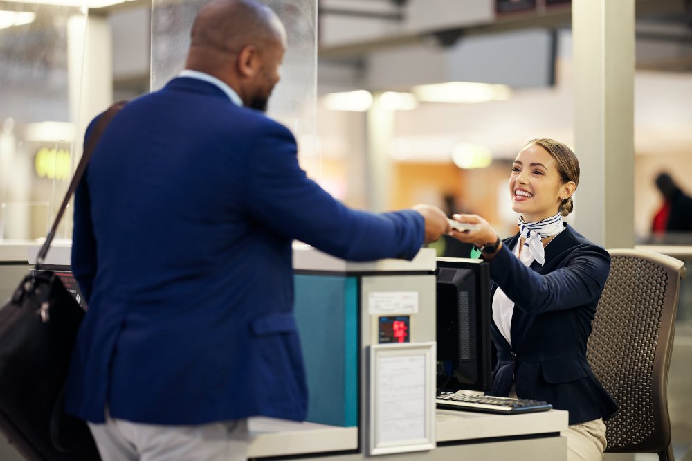 Passenger Showing His Documents to Front Desk Woman
