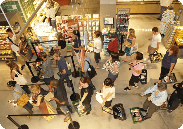 people standing in queues in retail store