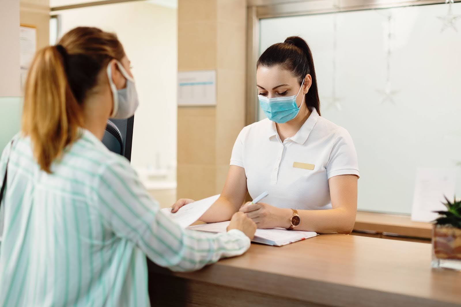 a woman checking-in at reception counter