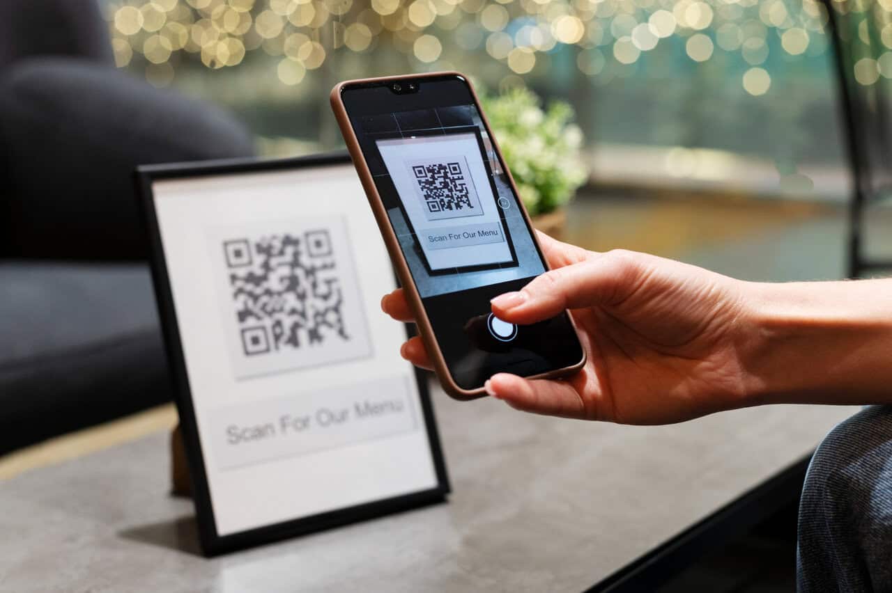 person scanning qr code with mobile to check-in